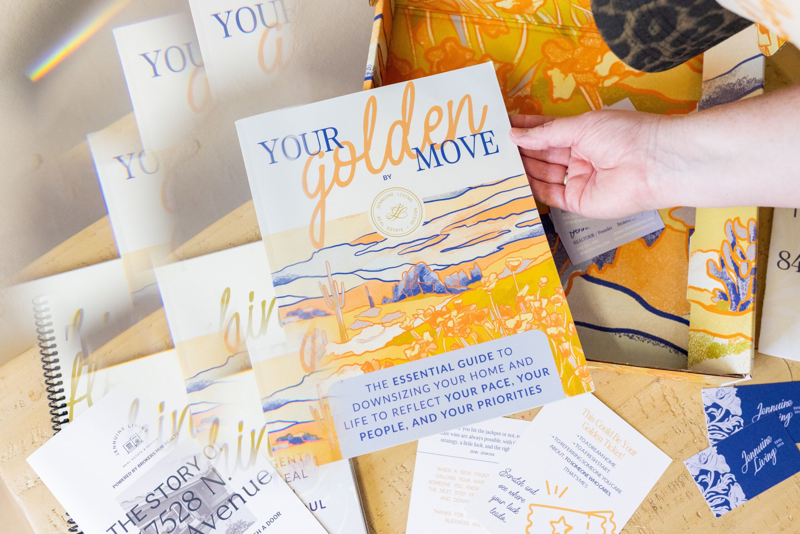 Hand holding a printed Golden Move Guide from Jennuine Living.